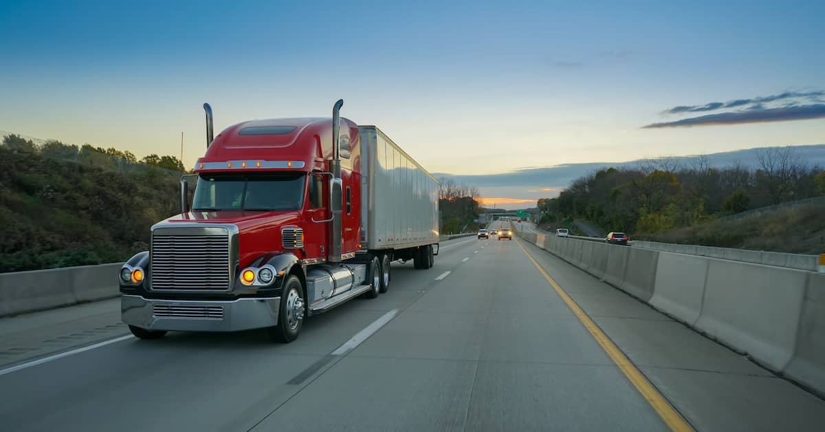 a semi truck drives on a highway | Studinski Law, LLC